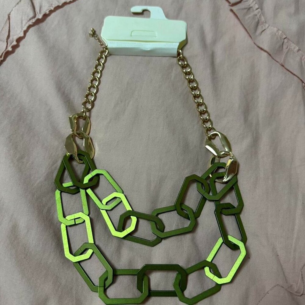 Green chain necklace with gold accents.